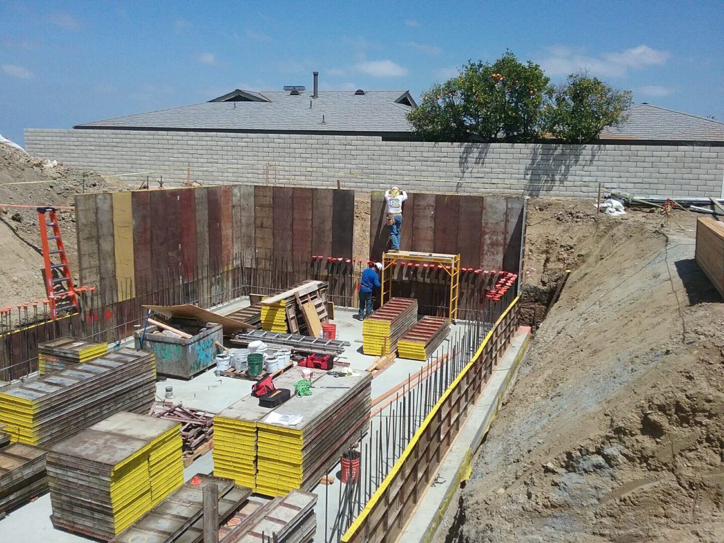 A construction site with workers and equipment on the ground.