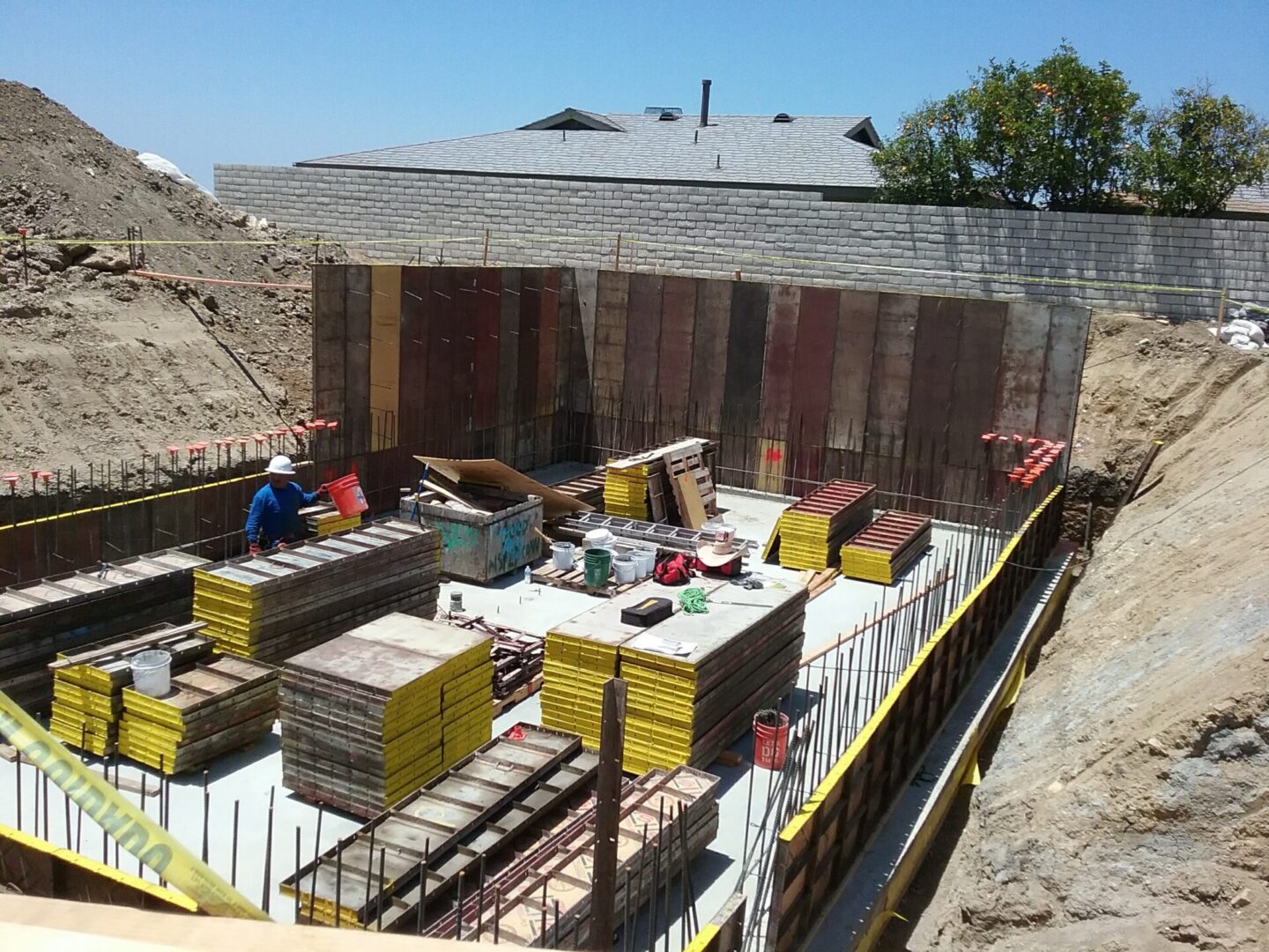 A construction site with workers working on the walls.