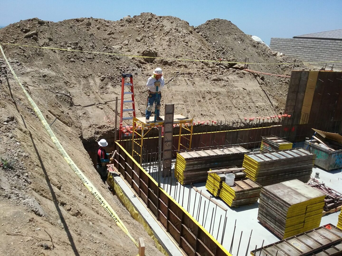 A man standing on top of a pile of dirt.