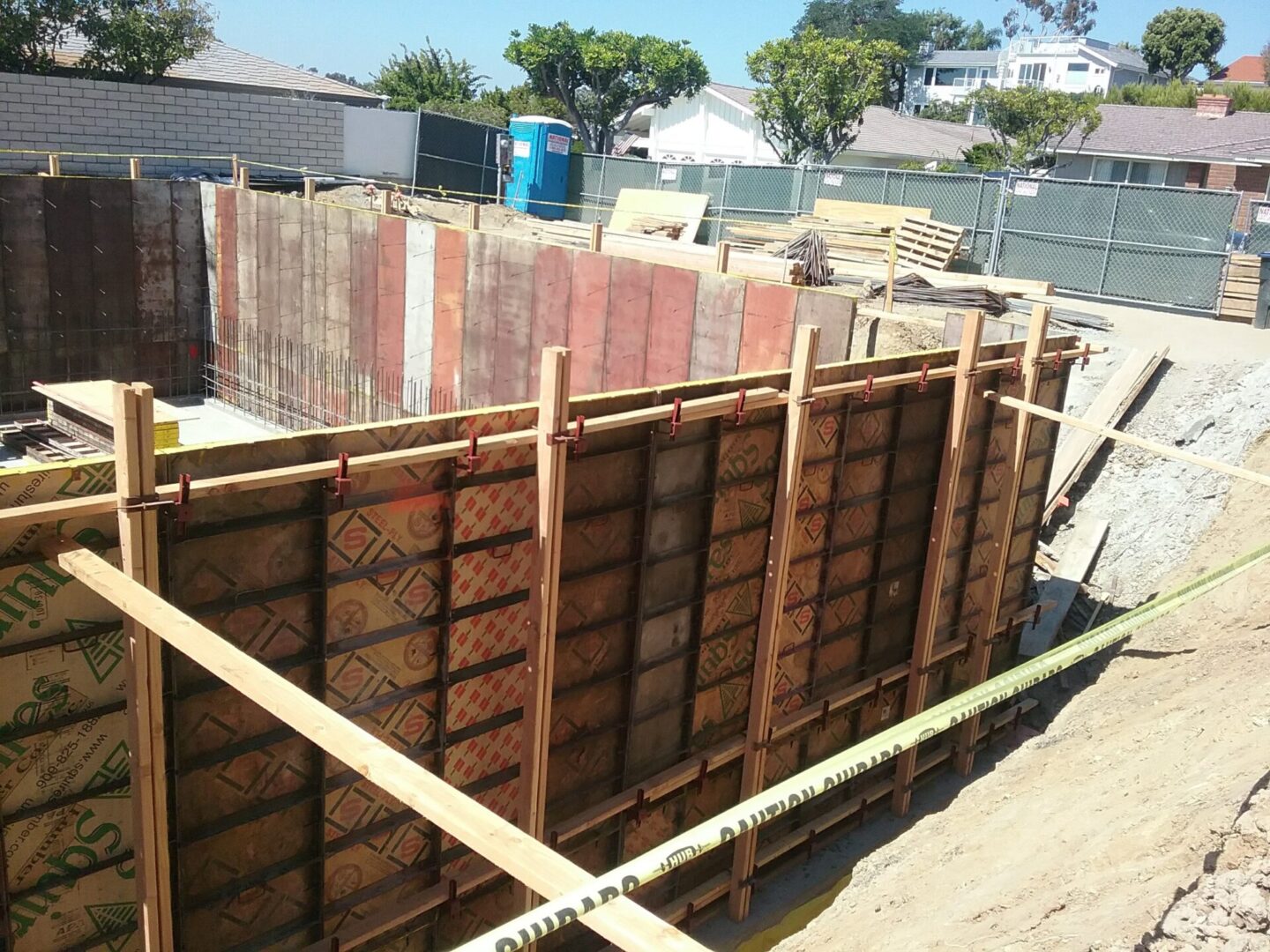 A construction site with wooden boards and concrete.