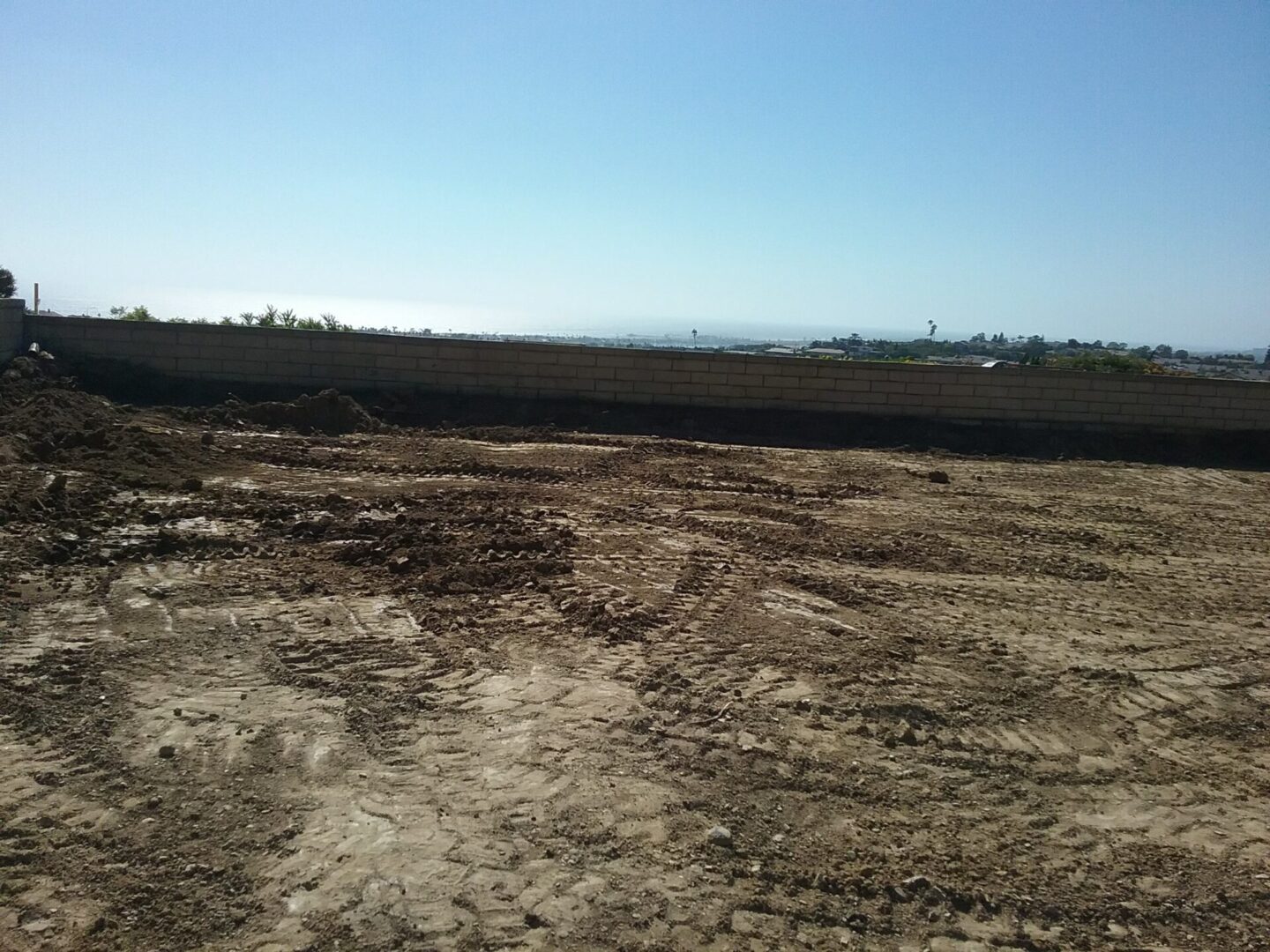 A dirt field with no grass and a sky background