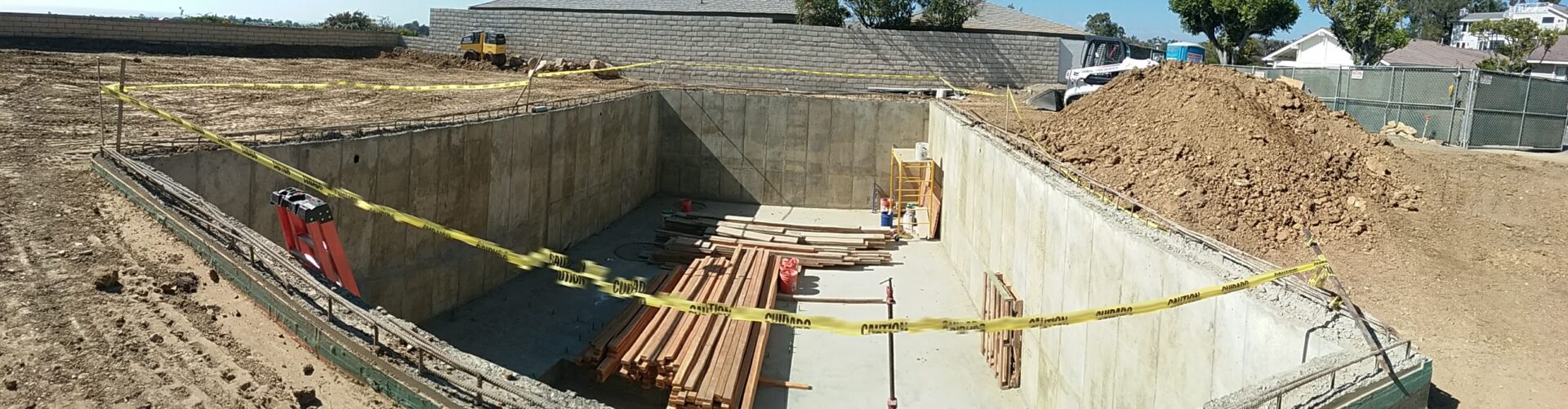 A construction site with some yellow tape and many wooden beams.