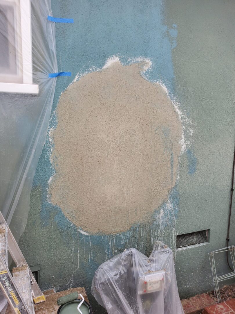 A wall with paint on it and the walls are peeling.