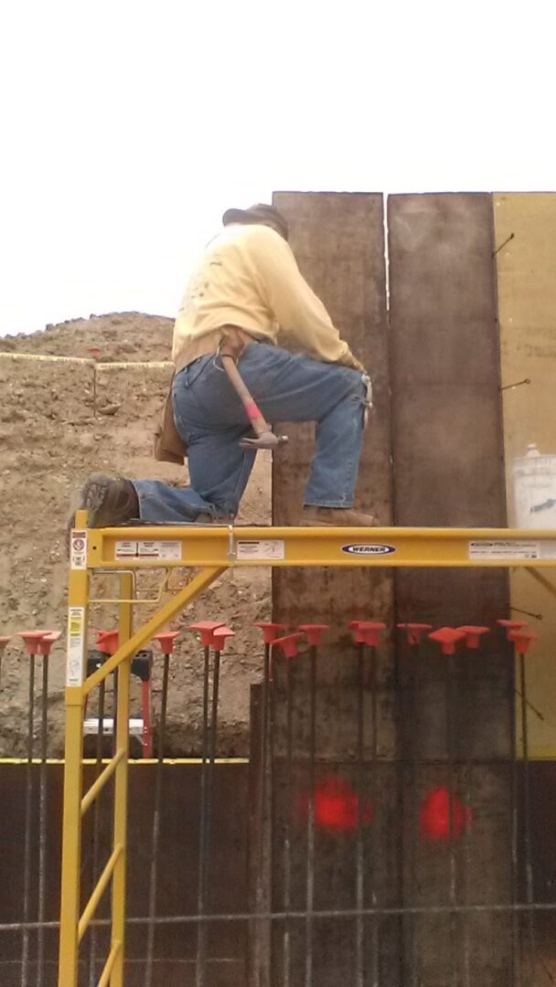 A man on a rail with a hammer