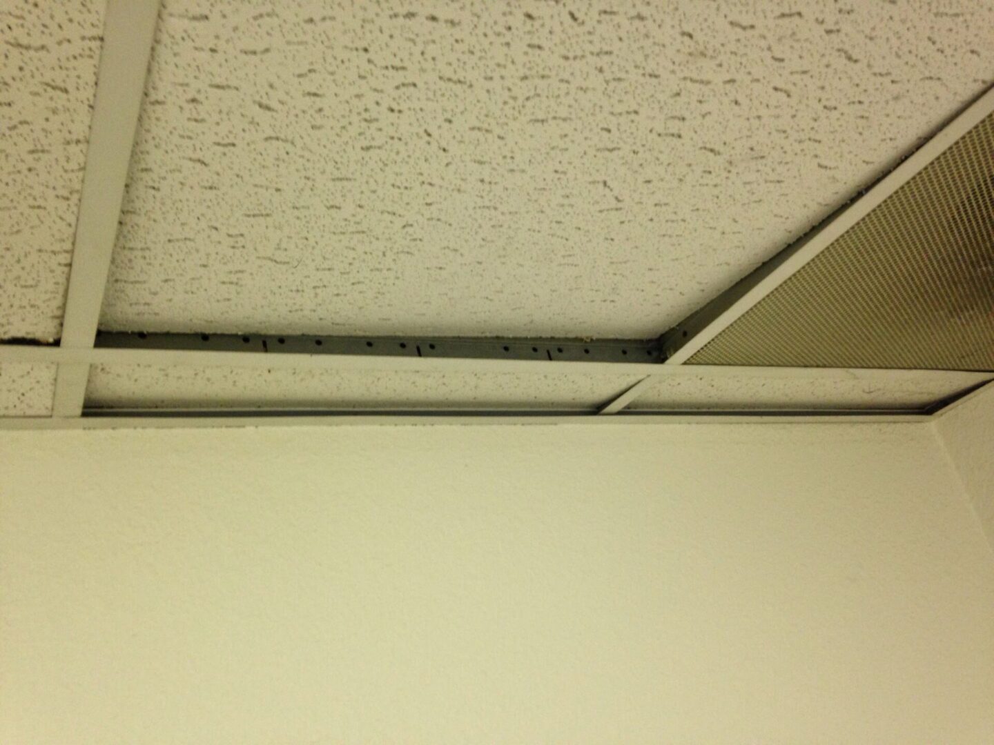 A ceiling with some kind of white paint on it