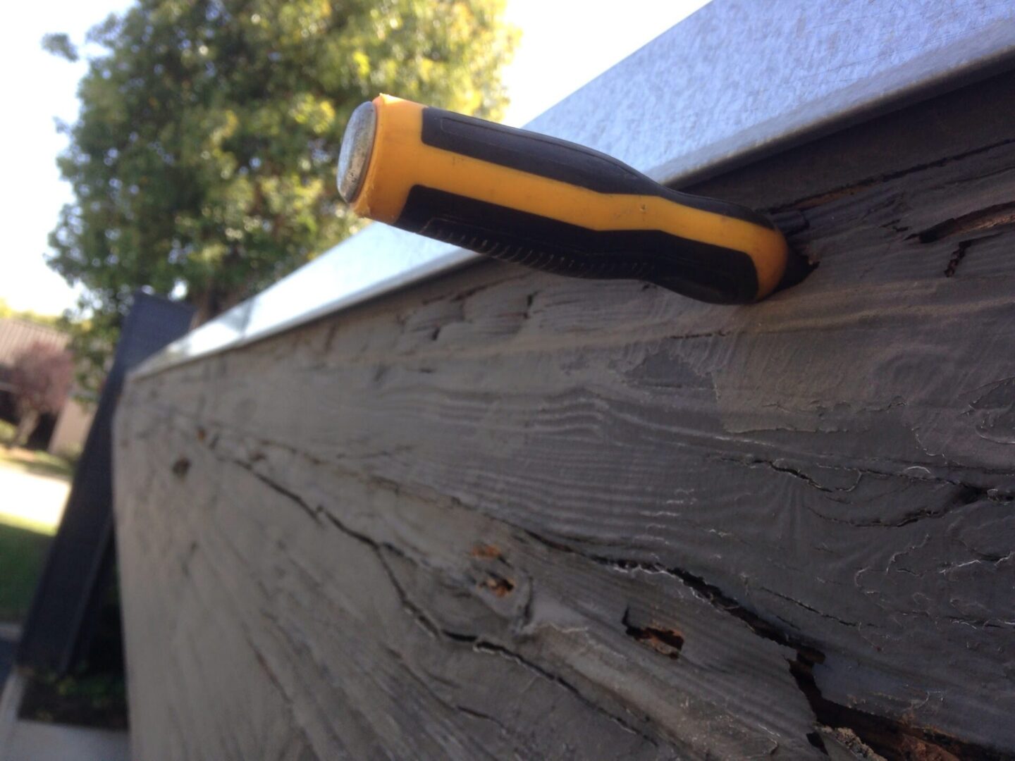 A flashlight hanging on the side of a building.