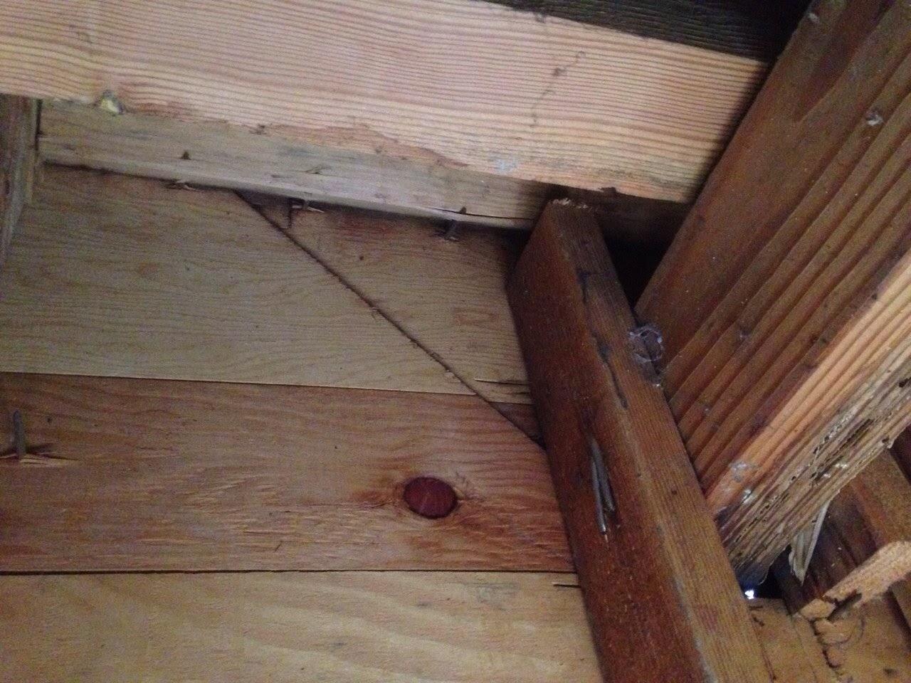 A wooden floor with some wood sticking out of it