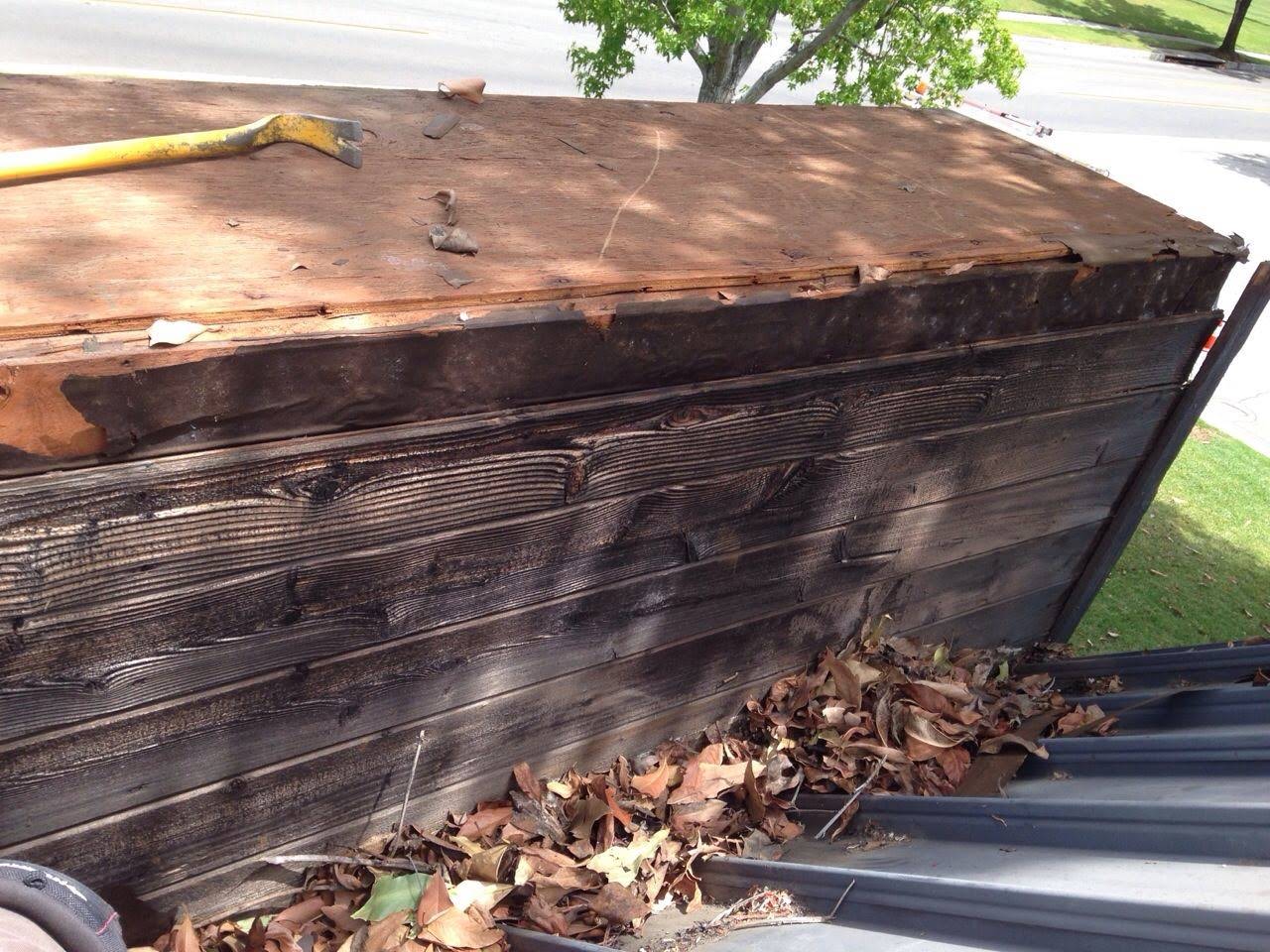 A wooden box with leaves on the ground