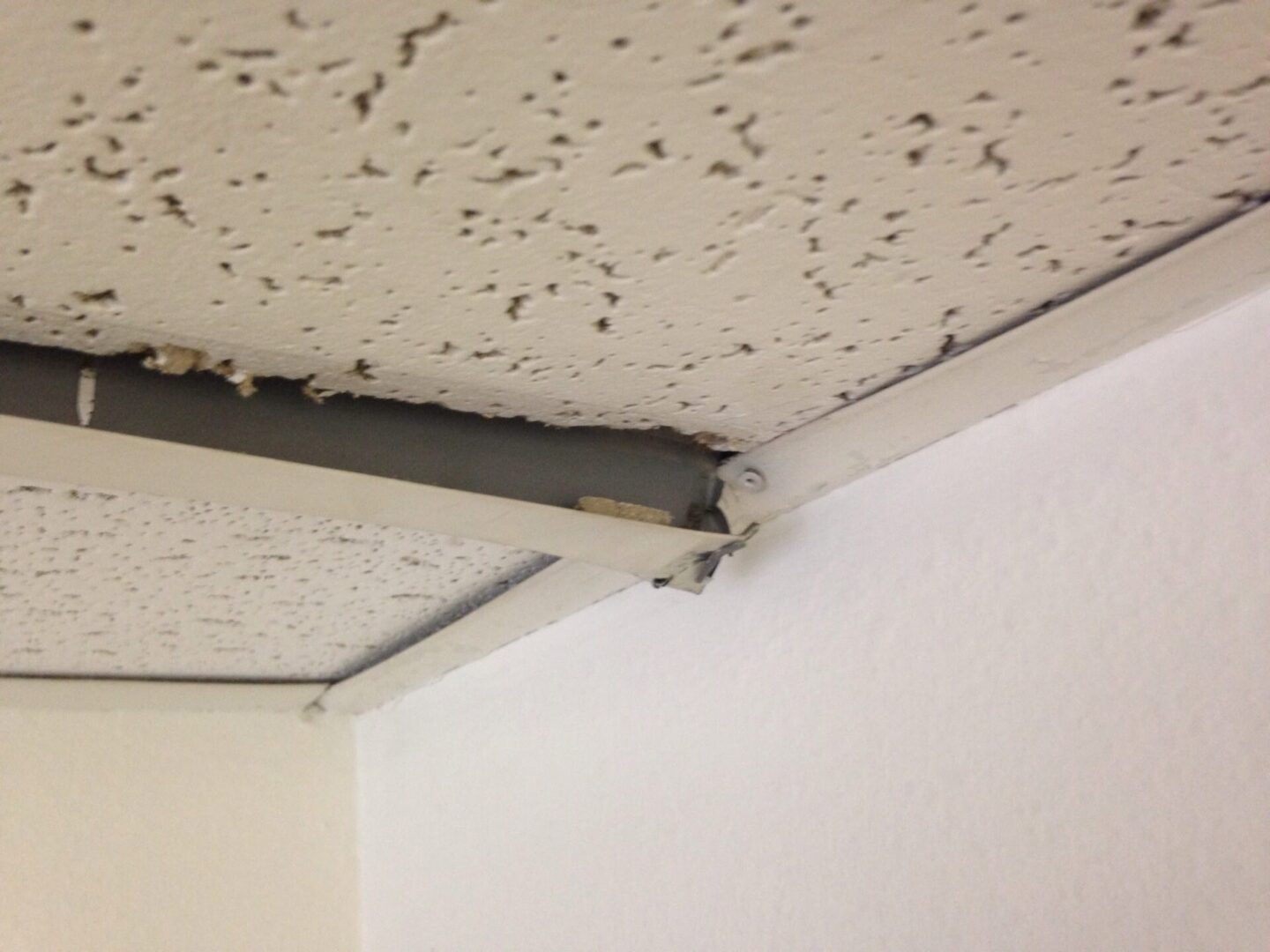 A ceiling with holes in it and some of the wall