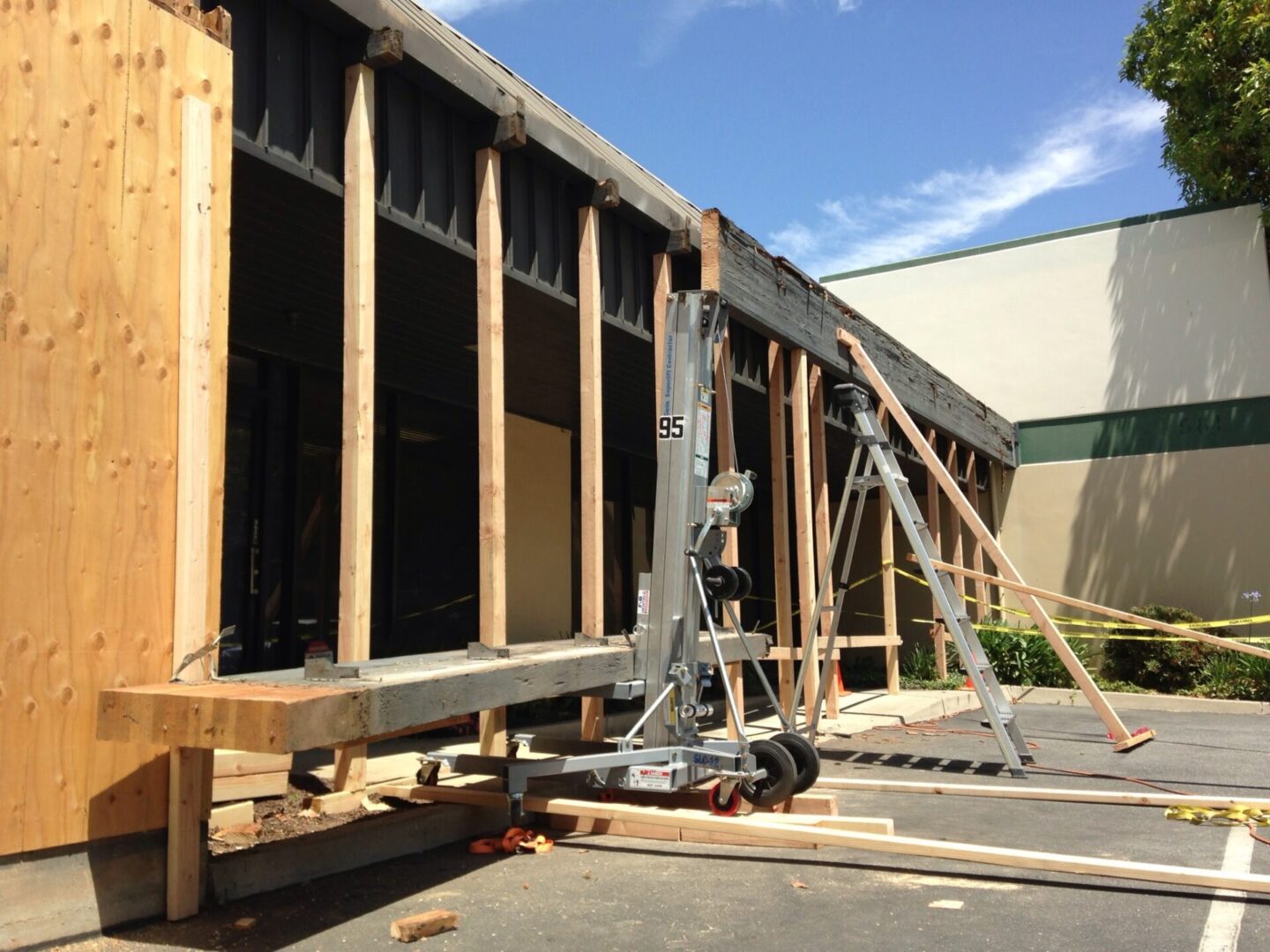 A building being built with some wood and scaffolding.