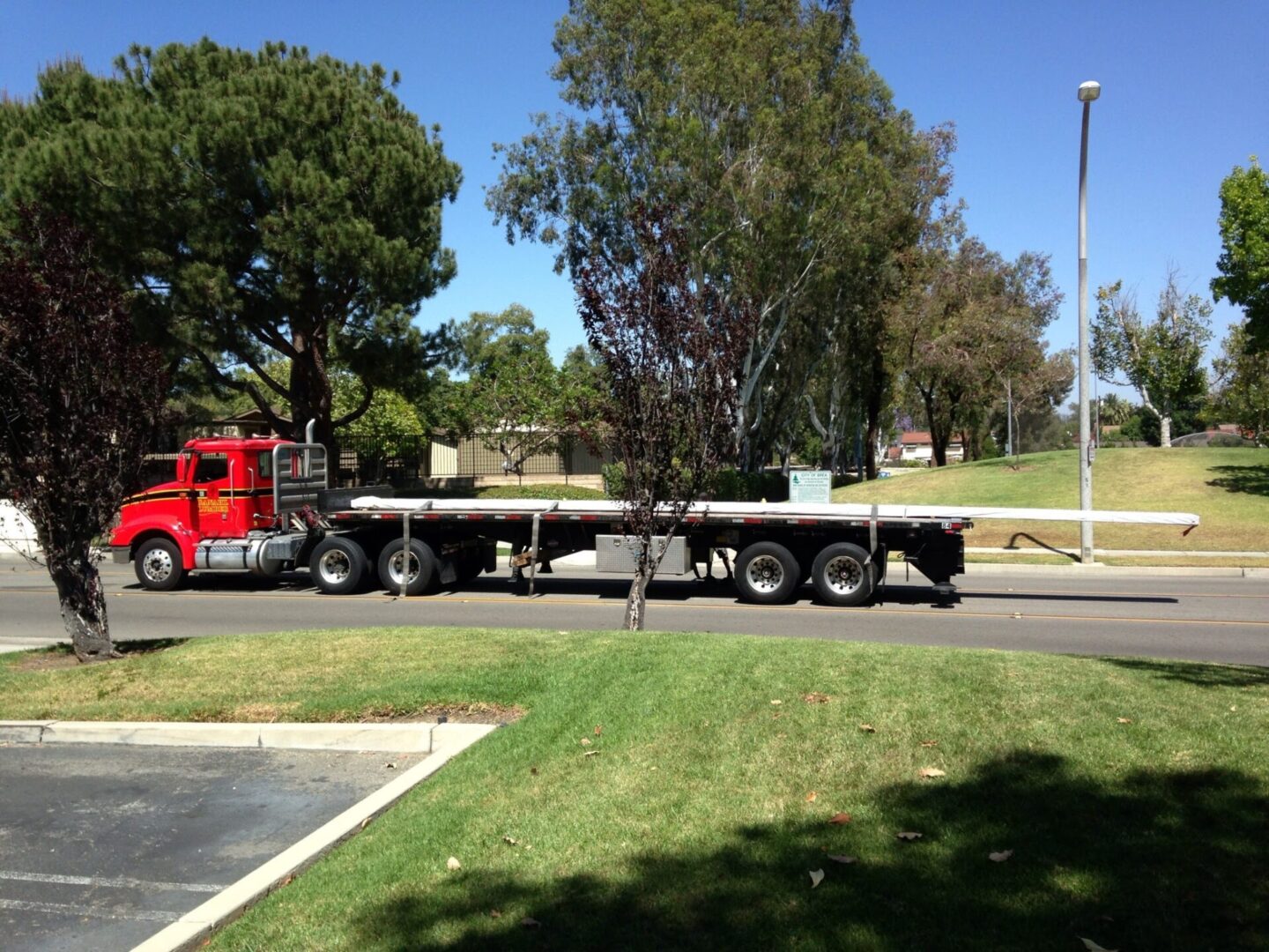 A red truck is parked on the side of the road.