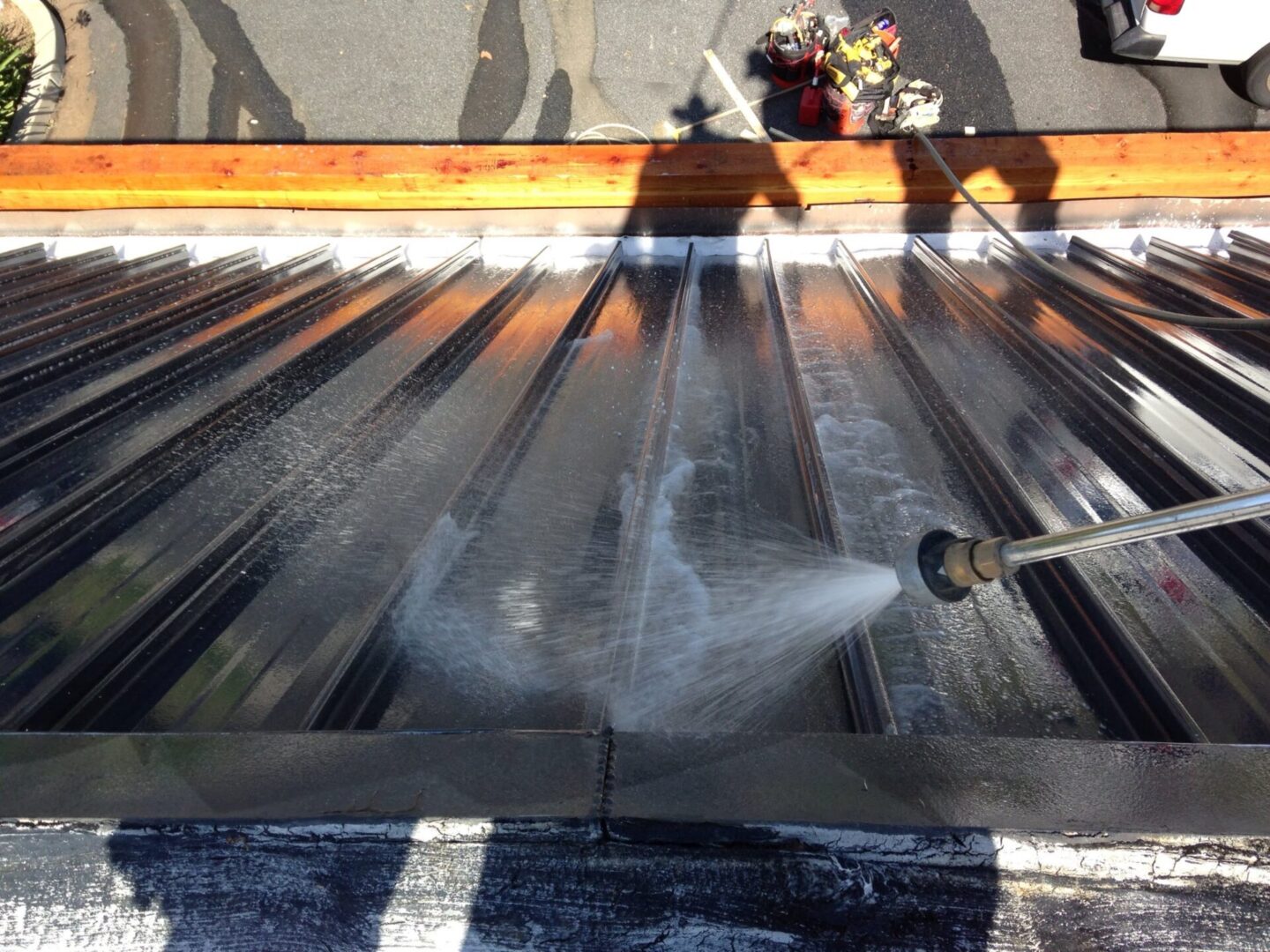 A person is washing the roof of a building.