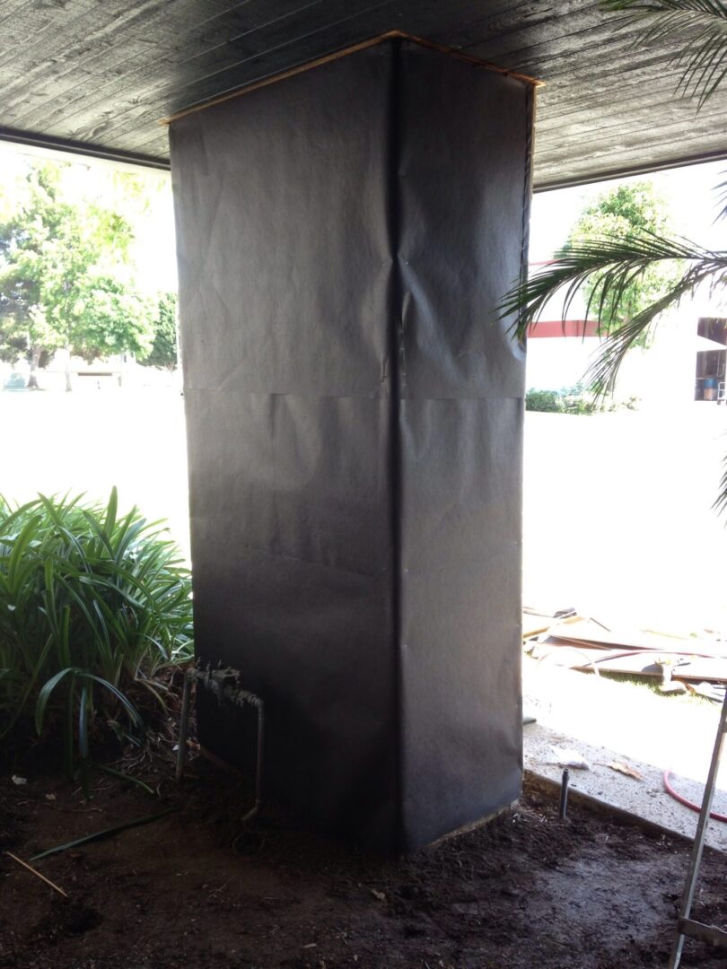 A corner of an outdoor area with a metal structure.