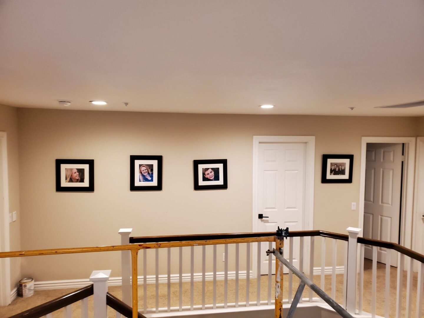 A room with several pictures on the wall.