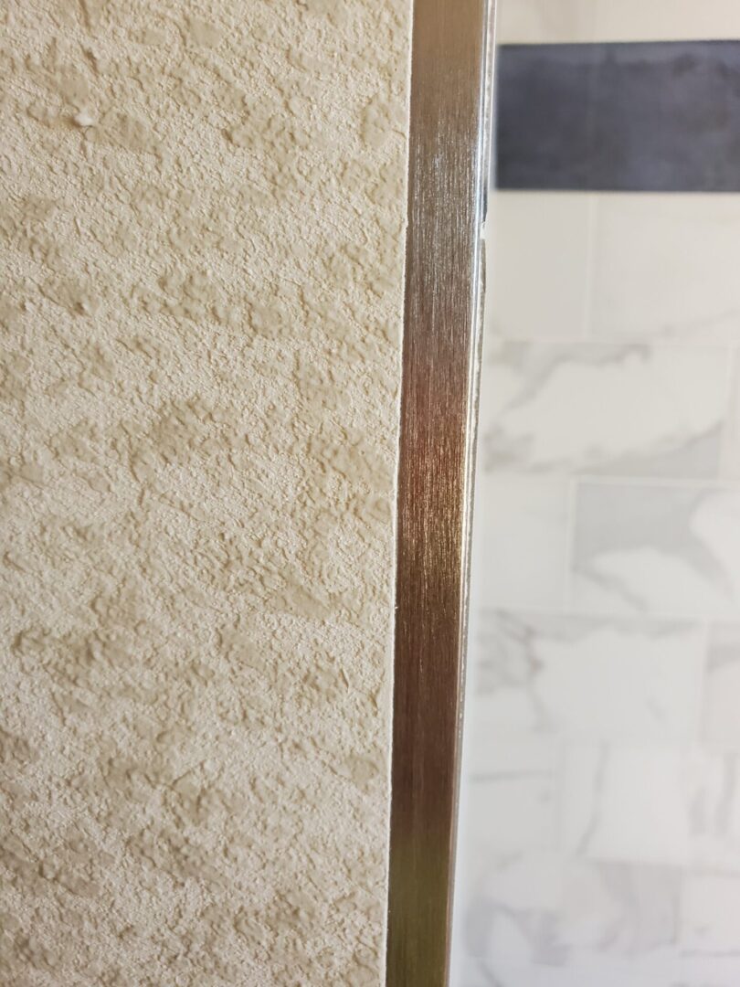 A close up of the corner of a bathroom