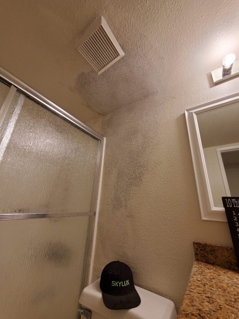 A bathroom with a shower and mirror in it