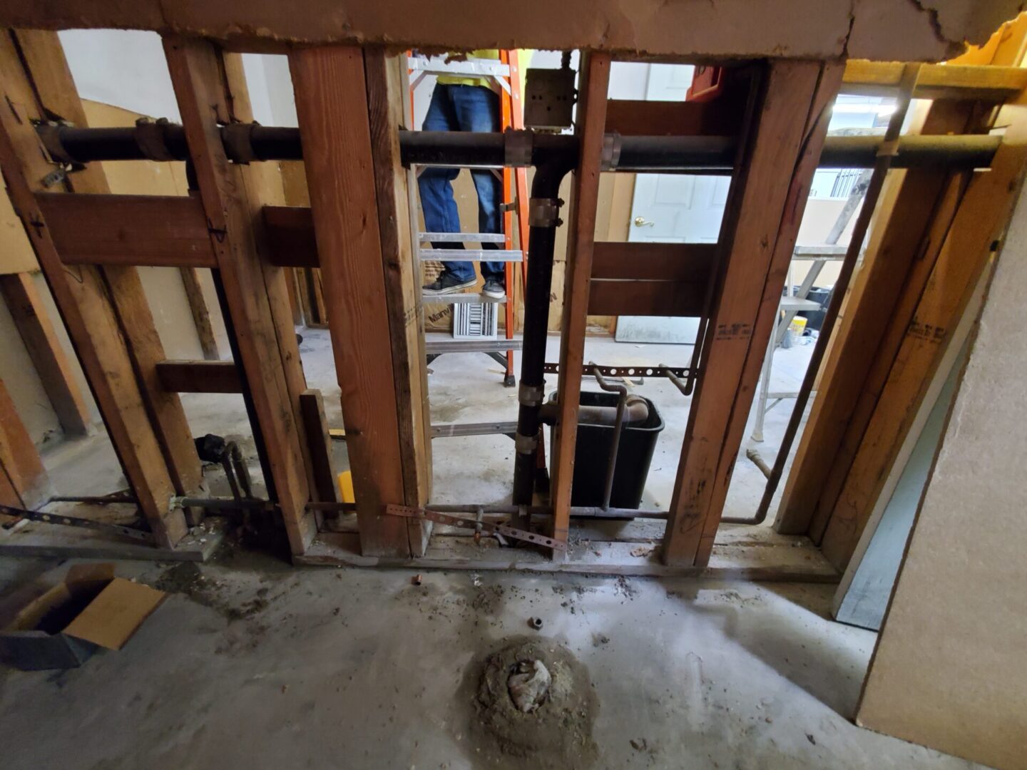 A room being remodeled with wood framing and concrete.