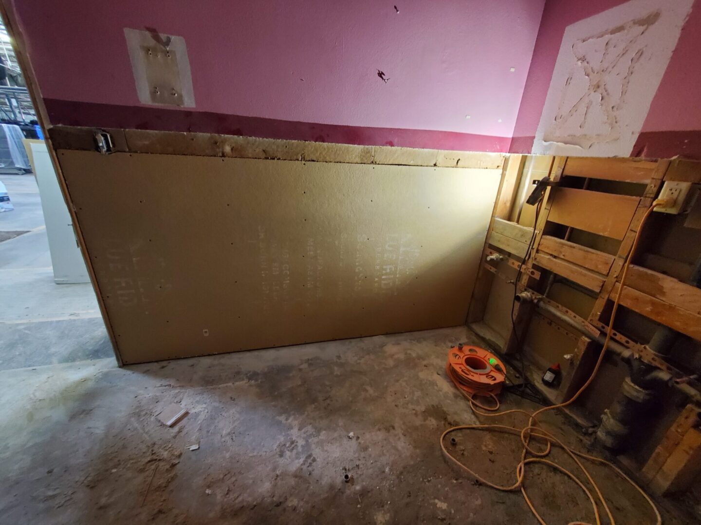 A room with a pink wall and a yellow floor