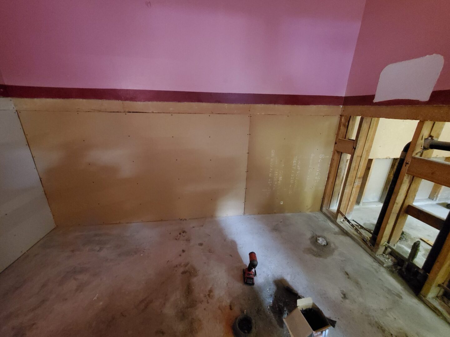 A room with pink walls and a fire hydrant.