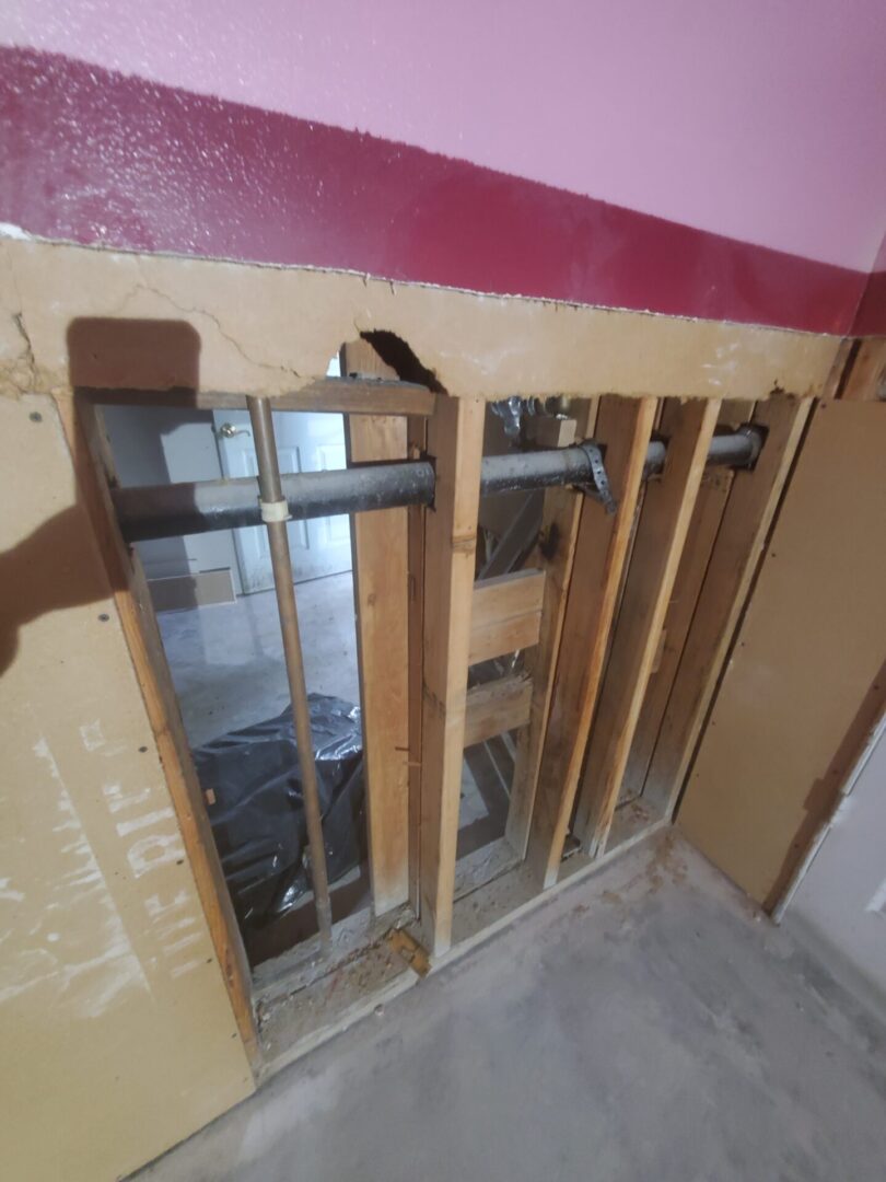 A bathroom with some wooden walls and pipes