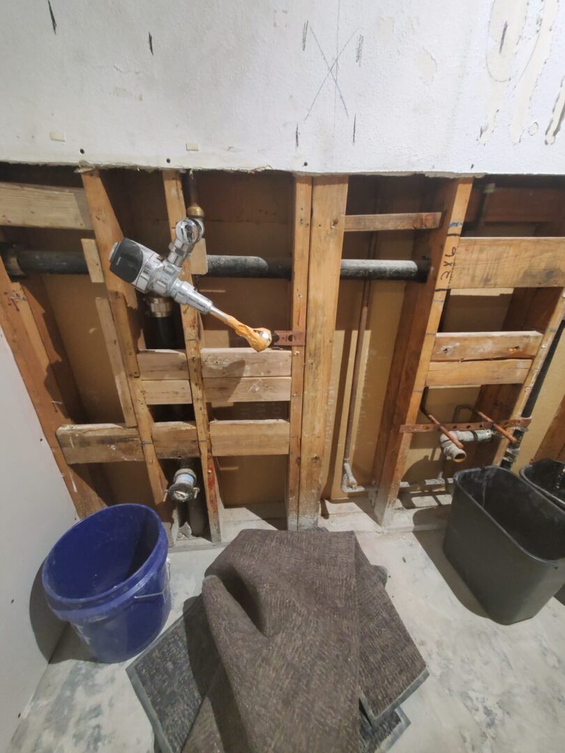 A bathroom with wood walls and floor being removed.