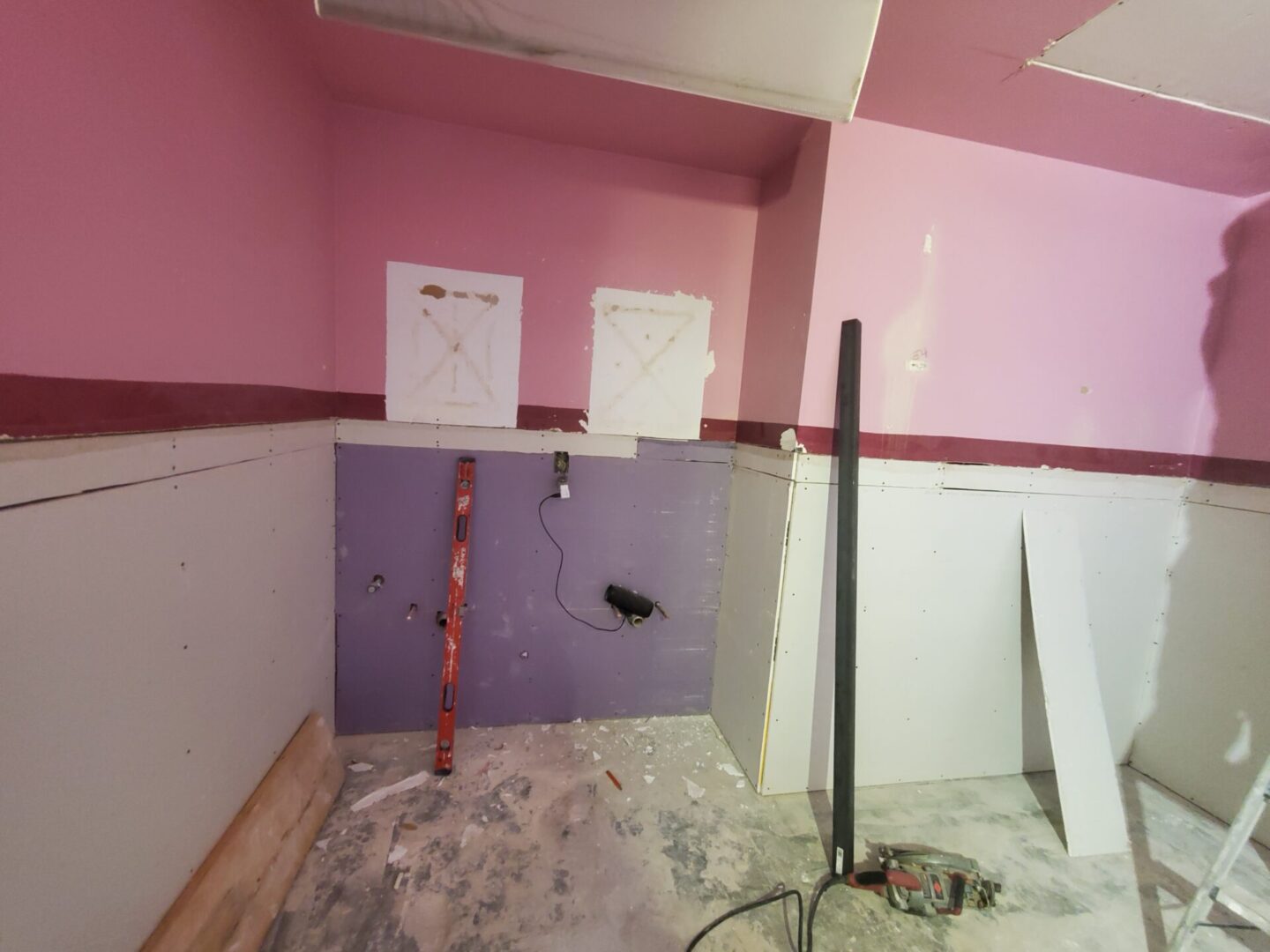 A room with pink walls and white trim.