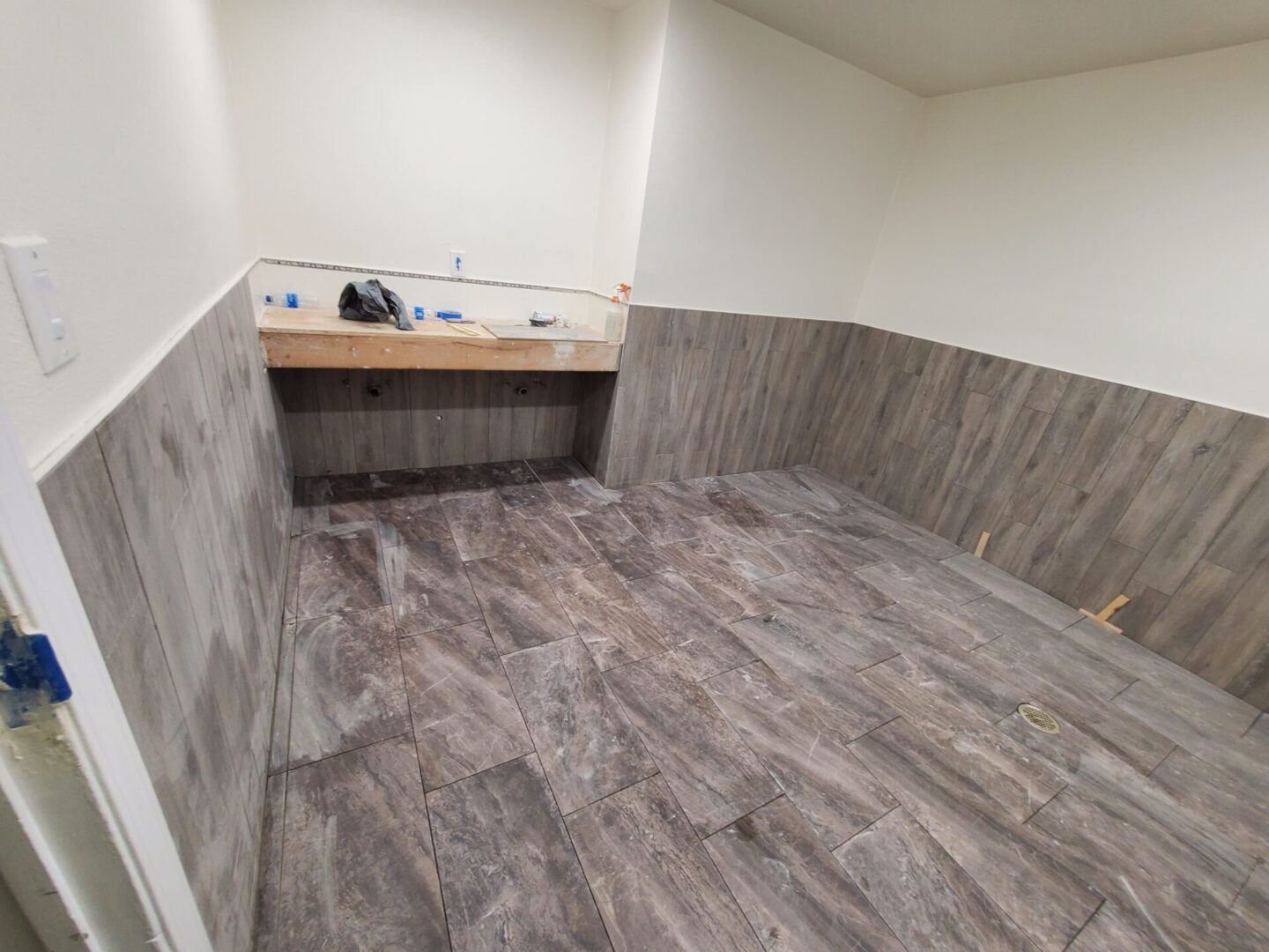 A bathroom with wood floors and a sink.