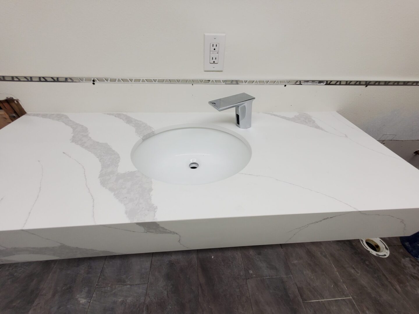 A white sink sitting on top of a counter.