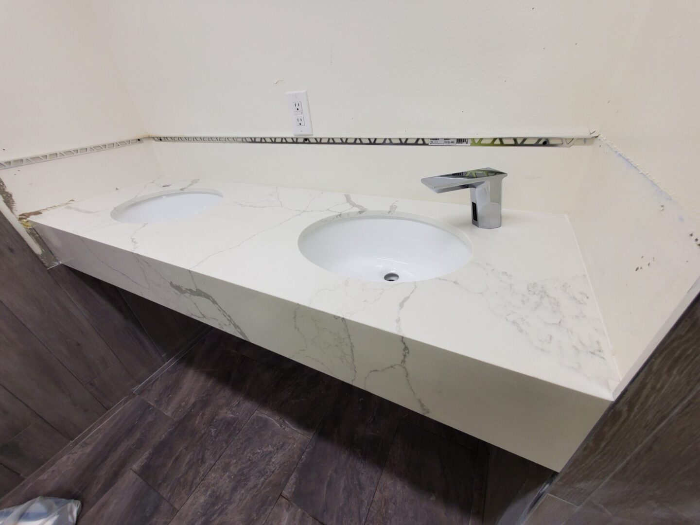 A white sink sitting under a bathroom counter.