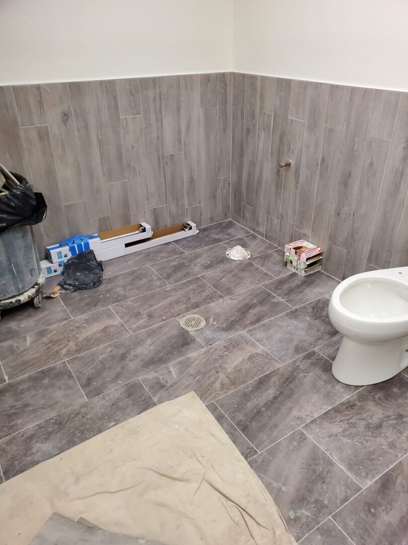 A bathroom with wood tile and white fixtures.