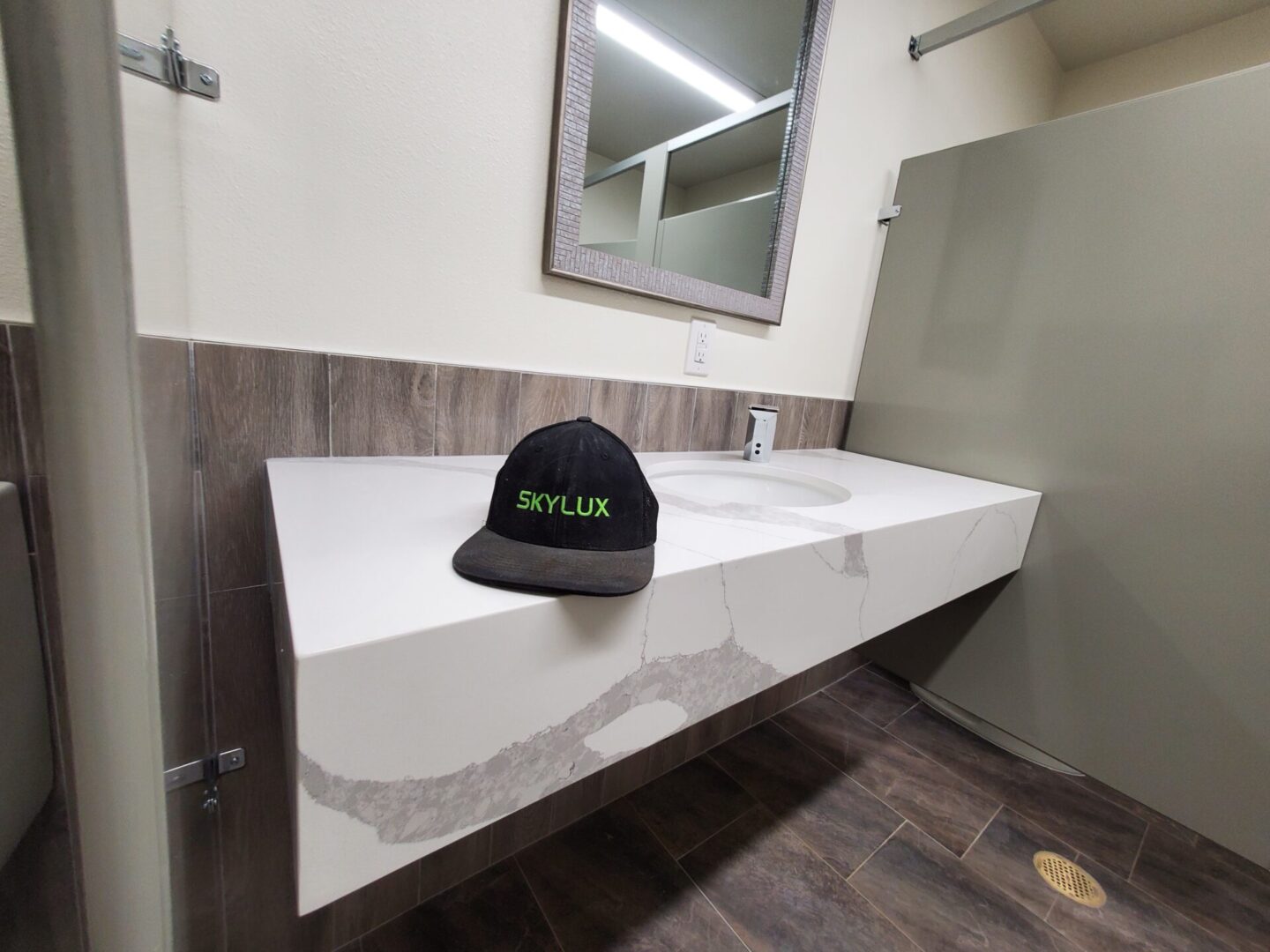 A bathroom with a sink and mirror in it