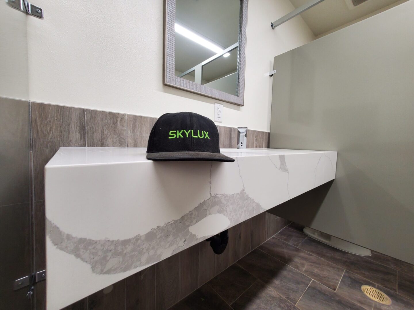 A black hat sitting on top of a white counter.