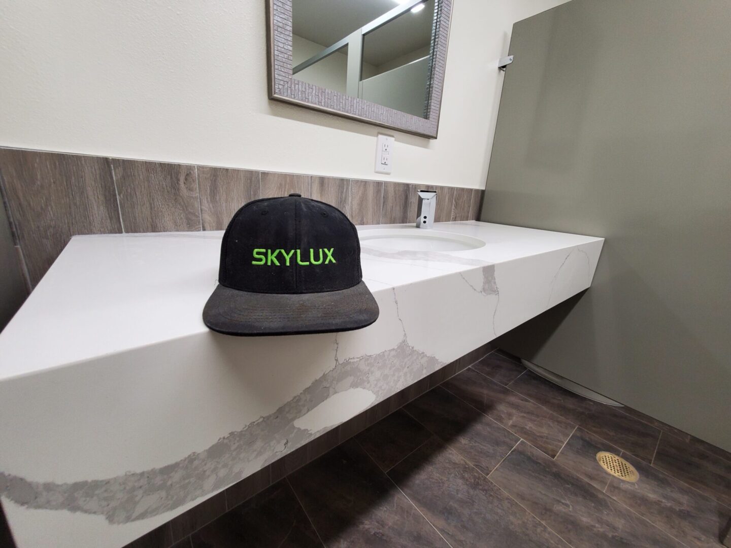 A black and green hat sitting on top of a white counter.