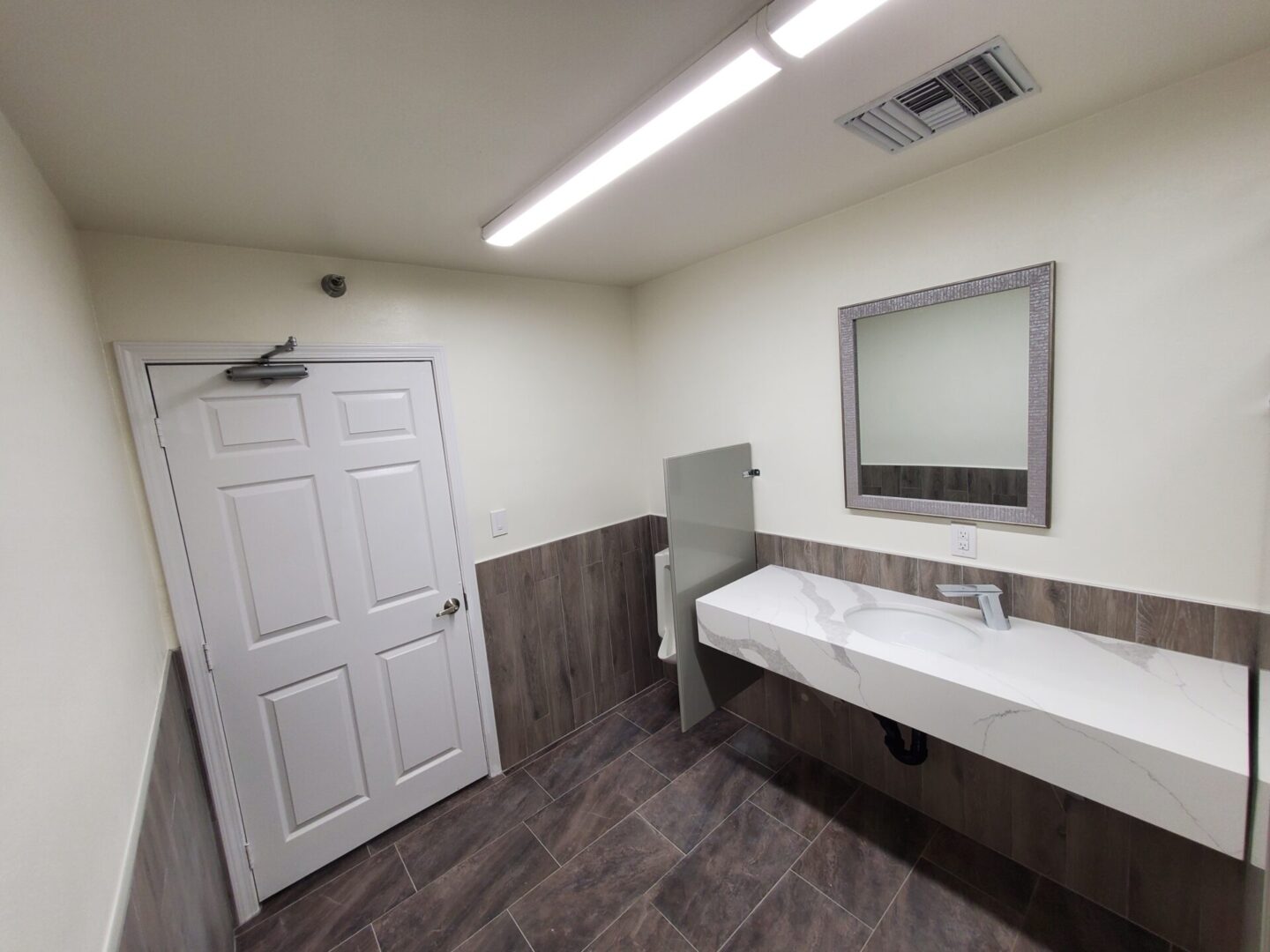 A bathroom with a sink and mirror in it