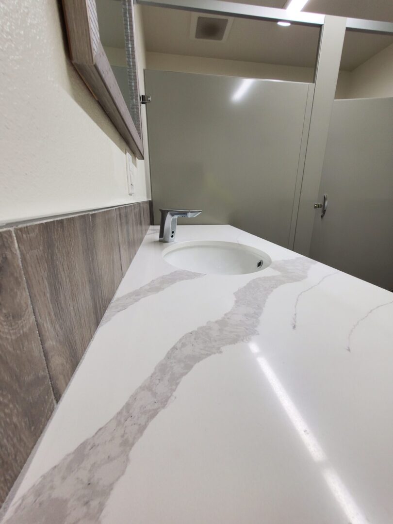 A bathroom with a sink and mirror in it