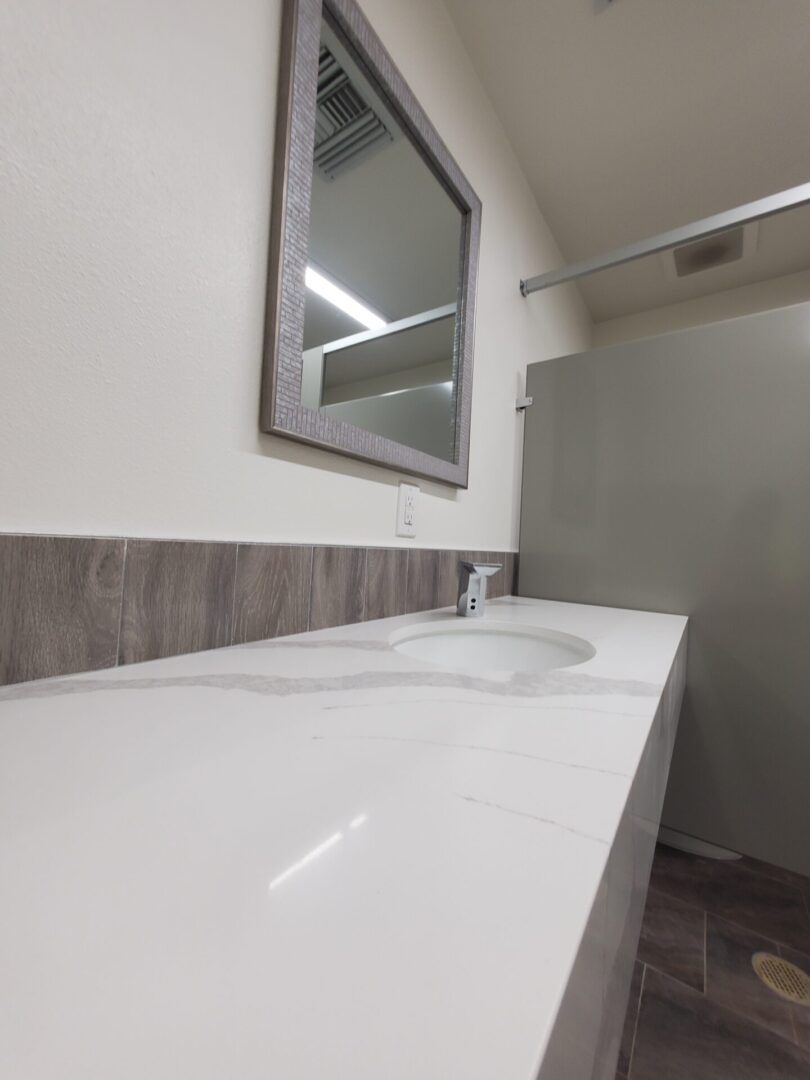 A bathroom with two sinks and a mirror.