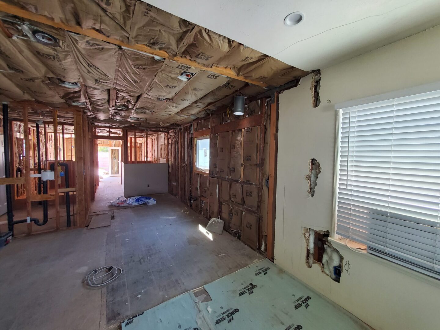 A room with walls and ceiling being remodeled.