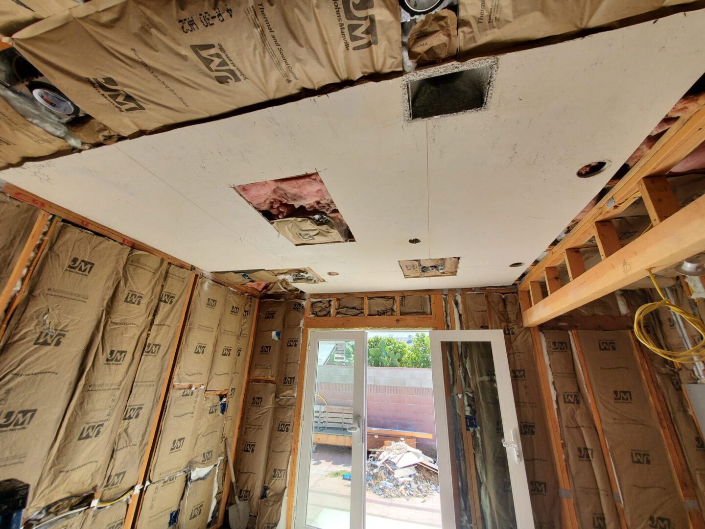 A room with some insulation on the ceiling