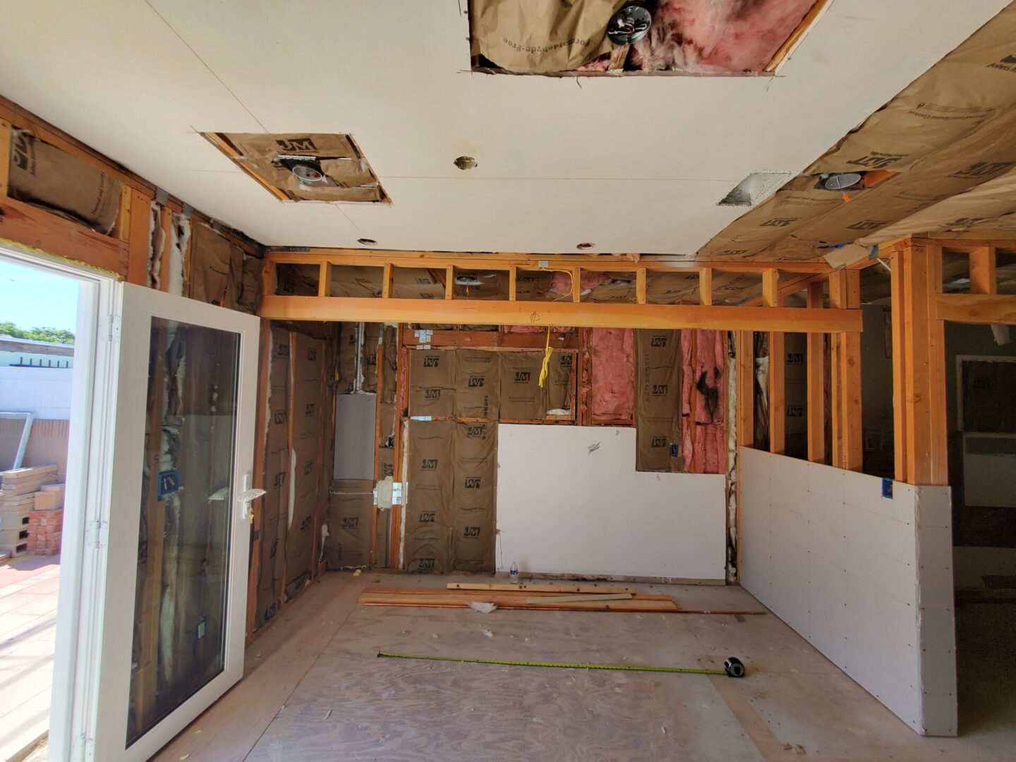 A room being remodeled with wood and drywall.