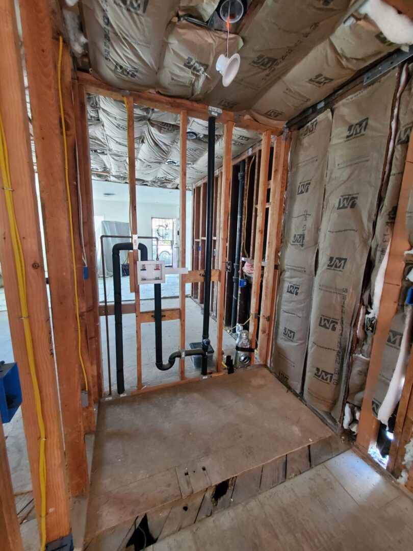 A bathroom being built with wood and insulation.