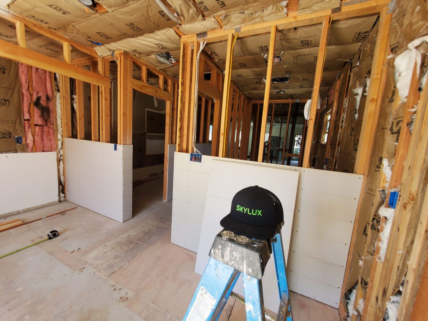 A ladder and some building materials in a room.