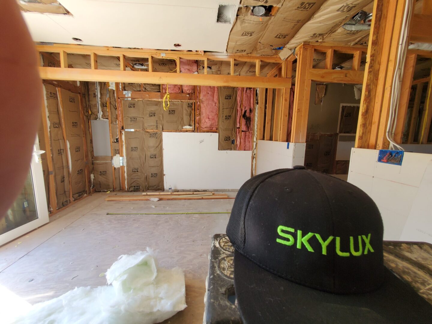 A room with walls and ceilings being remodeled.