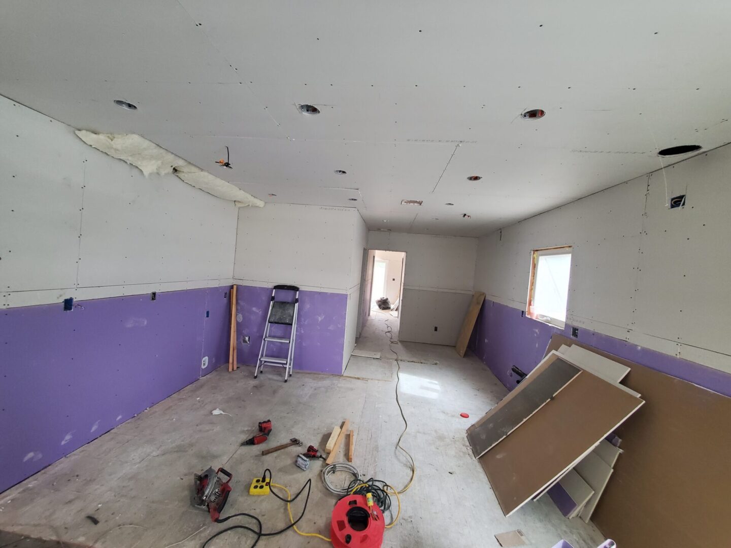 A room with purple walls and white ceiling.