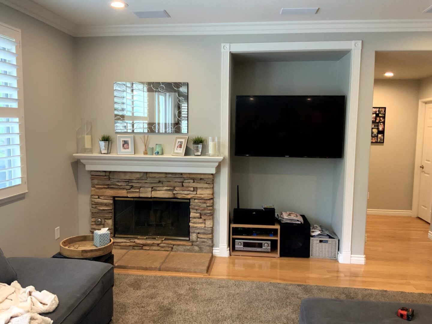 A living room with a fireplace and television.