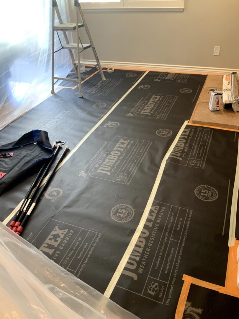 A room with some black insulation on the floor