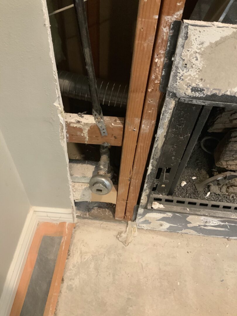 A fire place that is being built in the corner of a room.