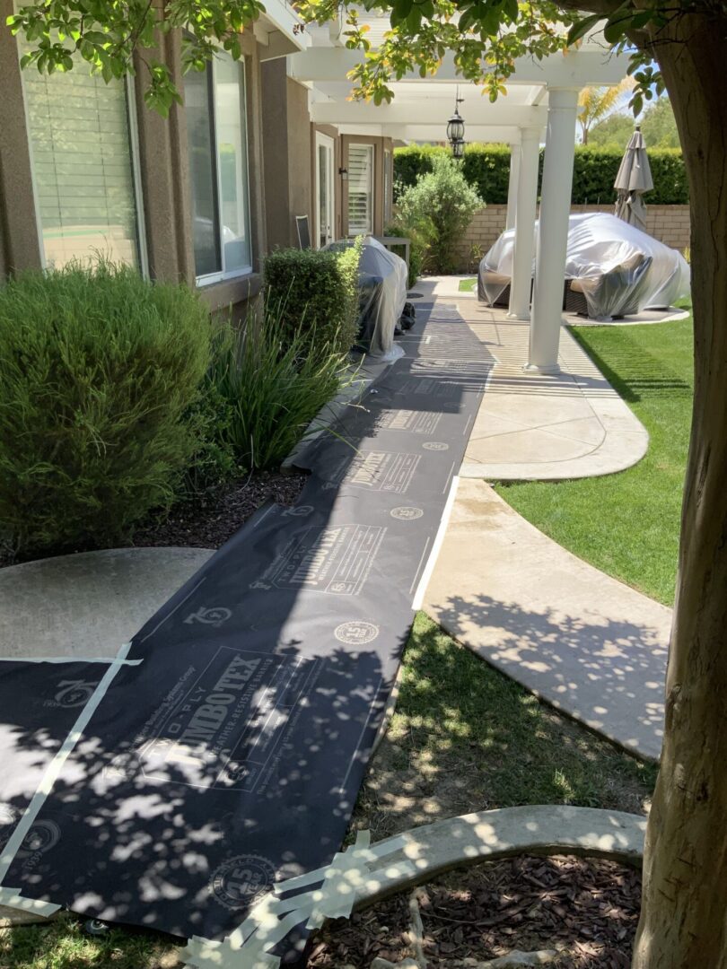 A walkway with trees and bushes in the background.