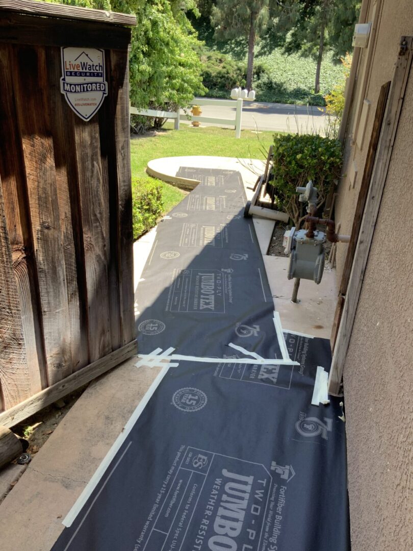 A walkway with some black tarps on it