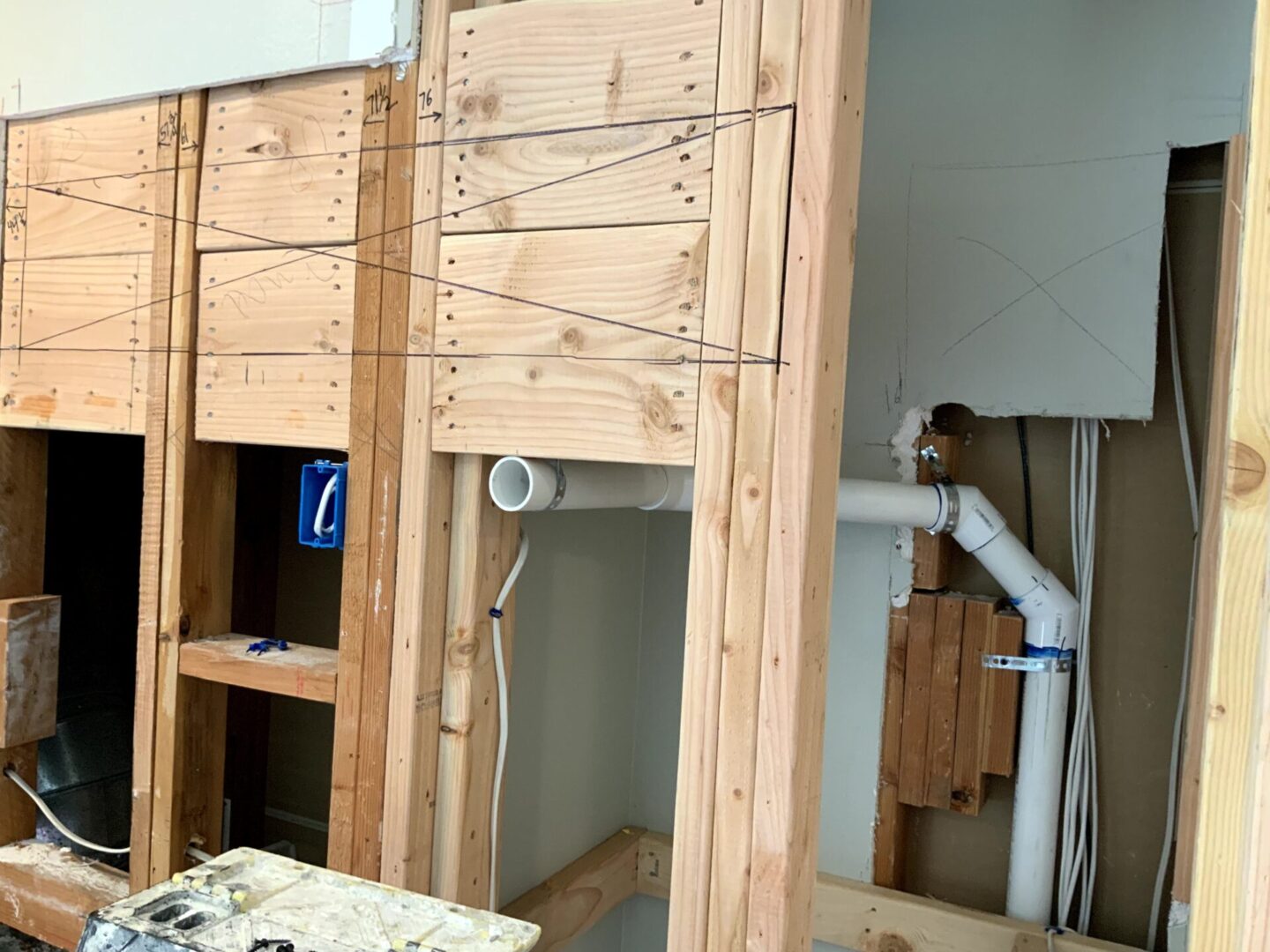 A man working on the wall of a room.