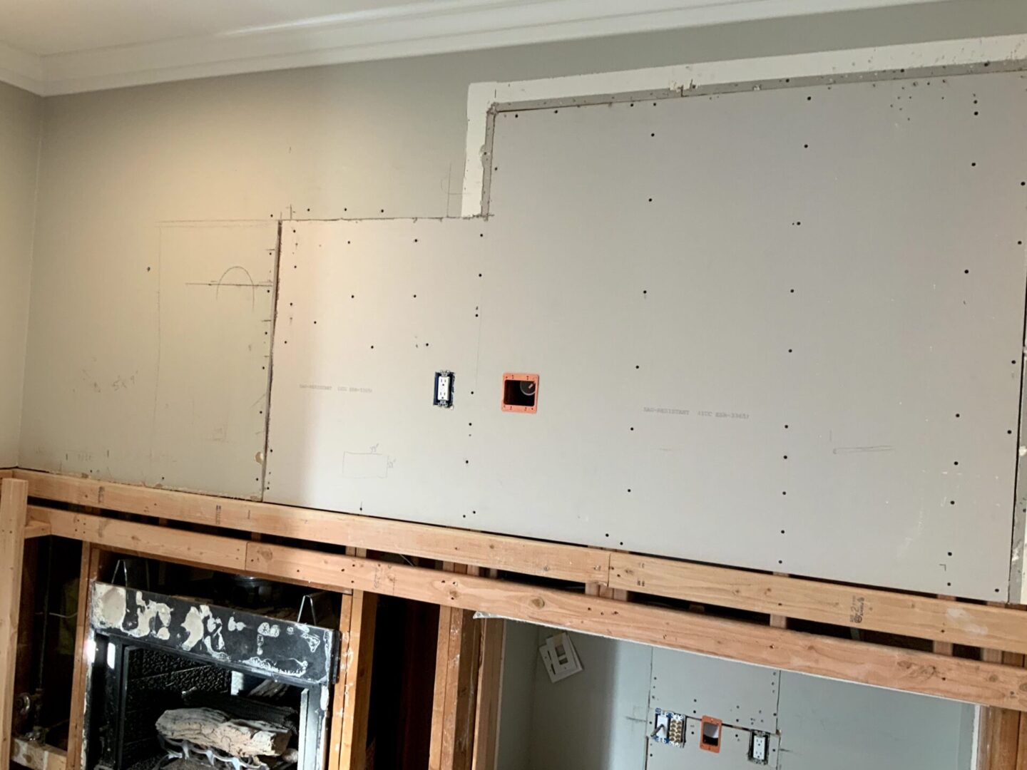 A room with some walls being built and the ceiling is in place.